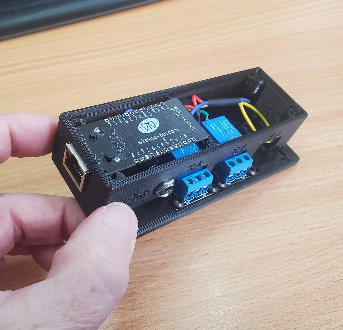 ArtSwitch with the lid off, showing the WT32-ETH01 board above the relay modules